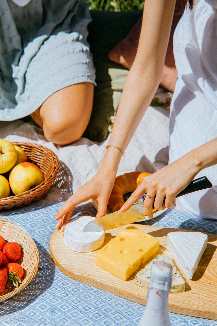 Fresh salad and sandwiches arranged on wooden board